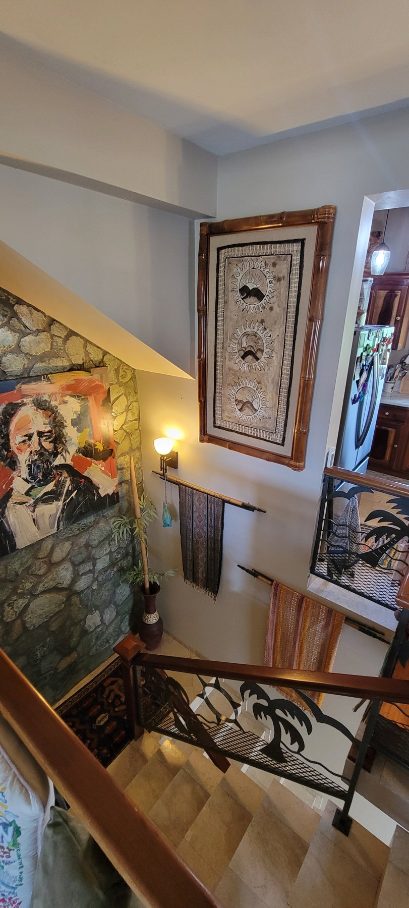 Green-slate stairwell with hand-wrought iron dolphin gate
